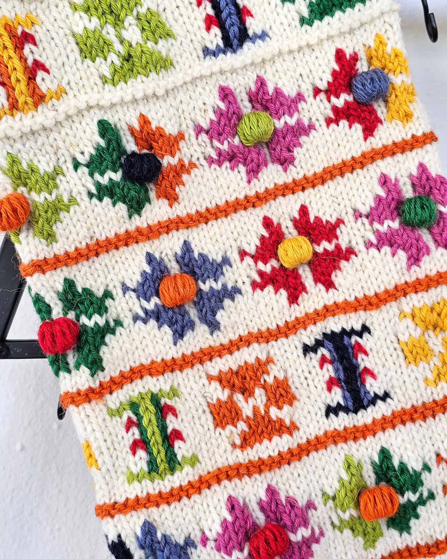Handmade stocking close-up showing Colorful Floral Pattern Pattern and raised bobbles