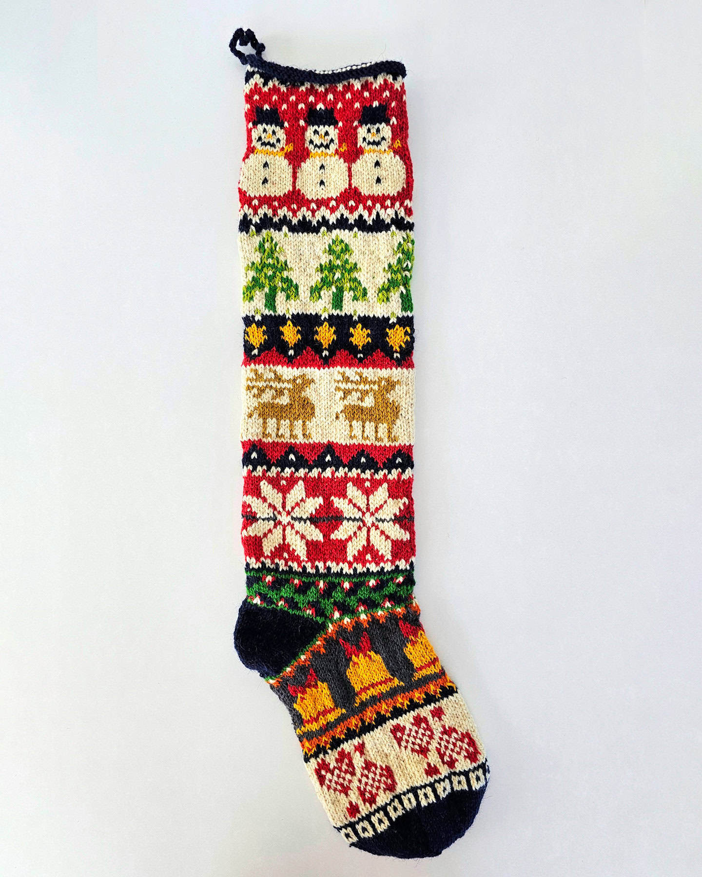 Handmade Christmas stocking adorned with a variety of traditional Christmas symbols, including Santa, reindeer, snowflakes, and Christmas trees.