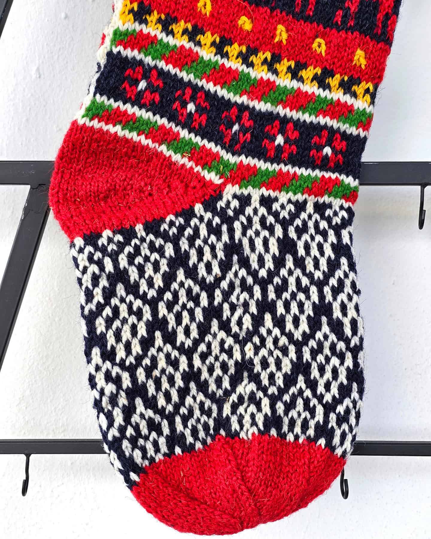 Close-up of the intricate reindeer design on the handmade Christmas stocking.