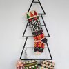 Handmade Boho Style Christmas stocking displayed on a Christmas tree shape with holiday decorations and a cozy ambiance.