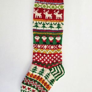 Handcrafted Christmas stocking featuring reindeer, Santa, and Nordic patterns in red, green, and cream.