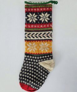Hand-knitted Christmas stocking featuring Nordic-inspired snowflake patterns, chevron stripes, and fair isle motifs in festive tones.