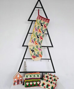 Colorful hand-knitted Christmas stocking featuring festive patterns of reindeer and trees in red, green, white, and beige.