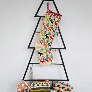 Colorful hand-knitted Christmas stocking featuring festive patterns of reindeer and trees in red, green, white, and beige.