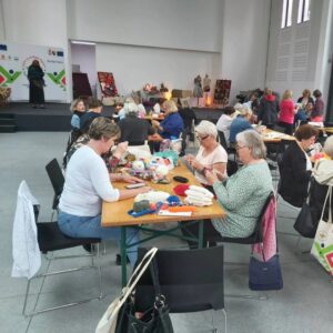 Unemployed women learning traditional knitting techniques at a BHcrafts training workshop.