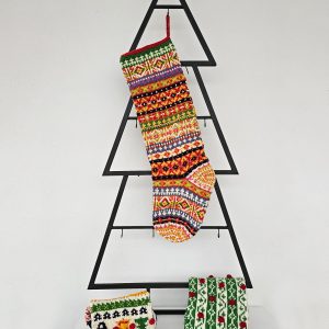Handmade colorful Christmas stocking hanging on mantel