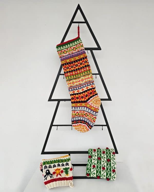 Handmade colorful Christmas stocking hanging on mantel