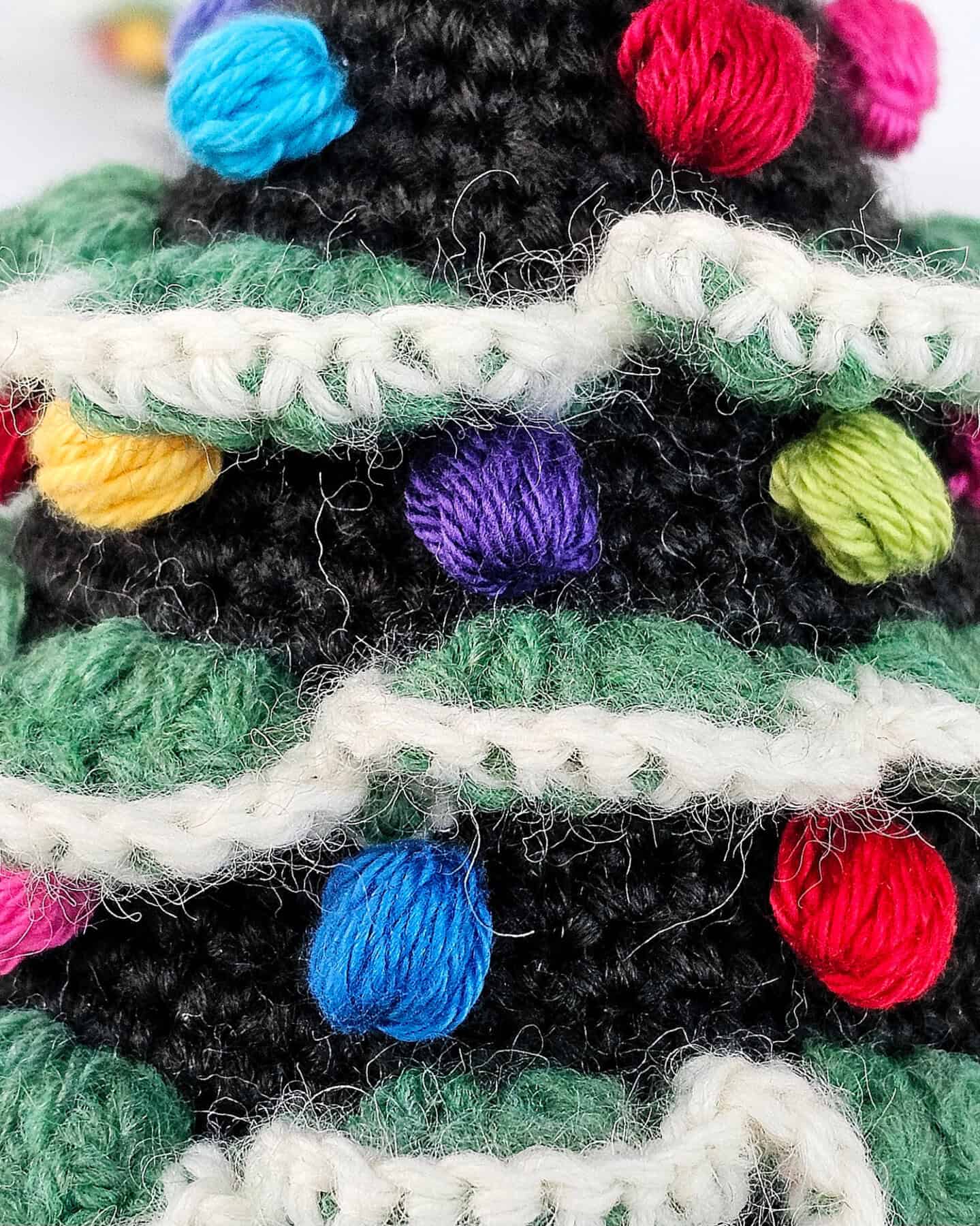 Close-up of multicolor bobble decorations on a fair trade crocheted Christmas tree ornament.
