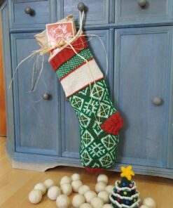 Personalized holiday stocking handmade from natural fibers, featuring festive red and green patterns.