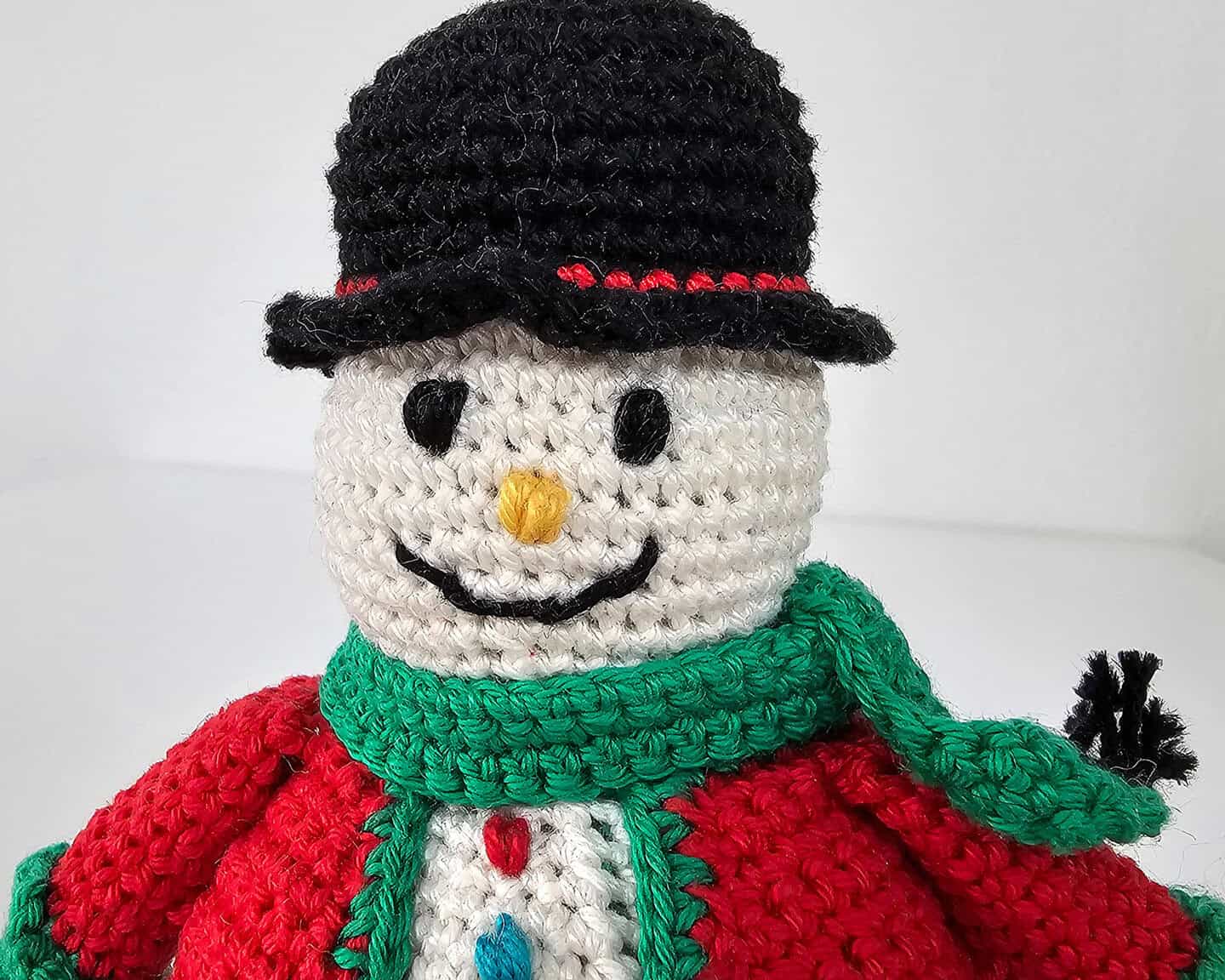 Fair trade crocheted snowman holiday decoration with black hat