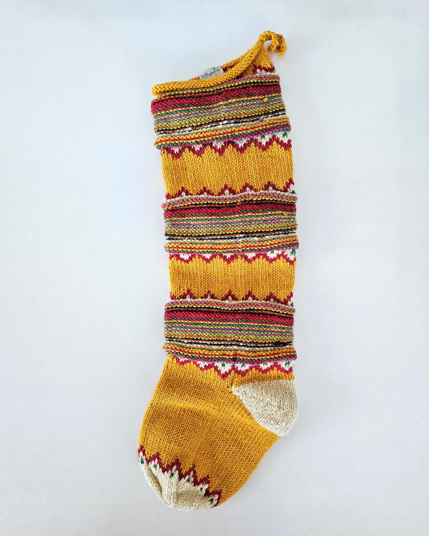 Hand-knitted yellow fair-trade chevron Christmas stocking will fit any holiday home decor style