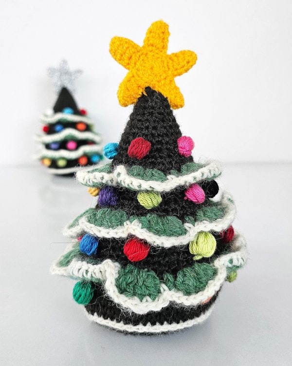 Handmade fair-trade crocheted Christmas tree home decor with multicolor bobble decorations and a yellow star topper, approximately 17 cm tall.