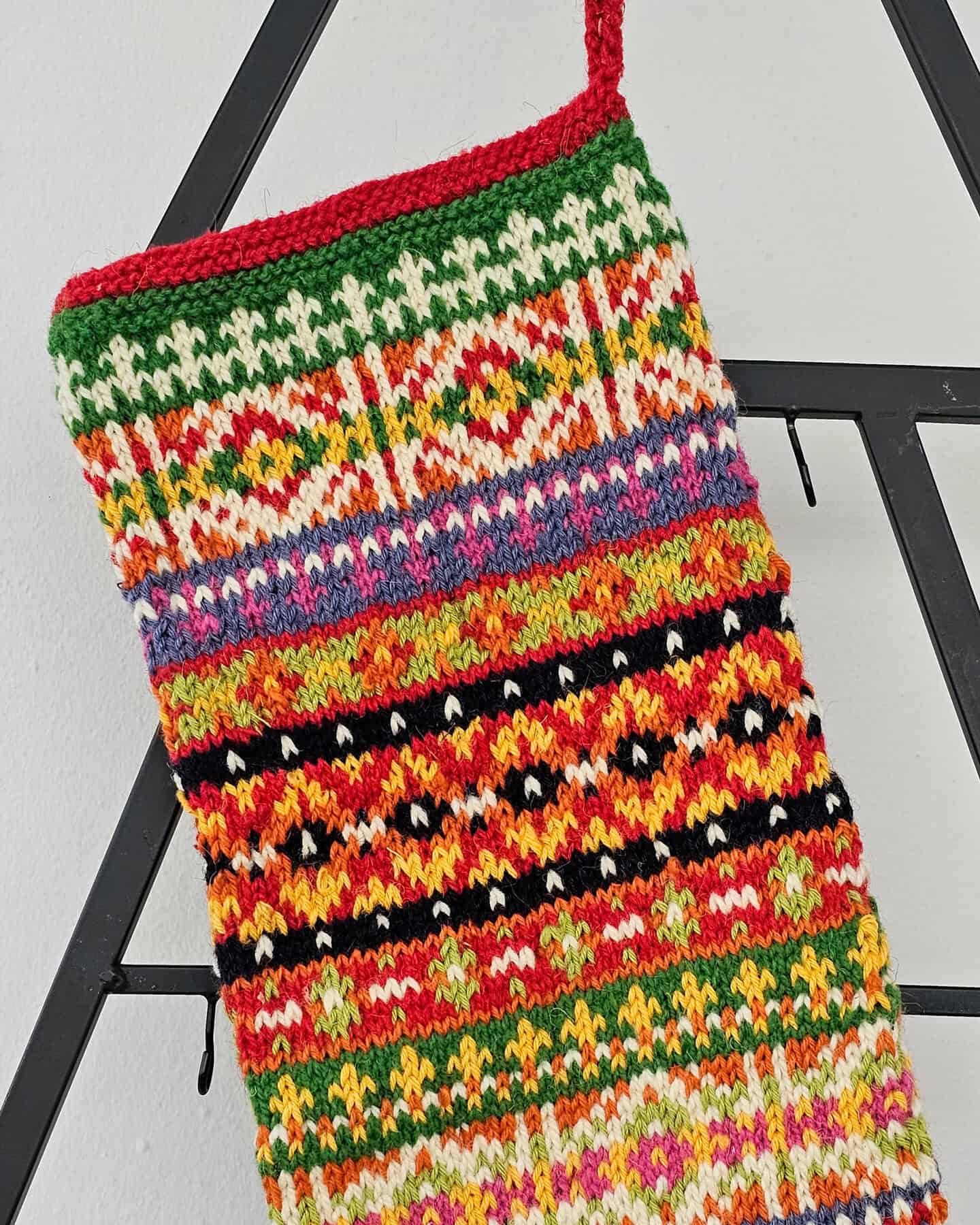 Gift-ready hand-knitted Christmas stocking in festive multicolor design