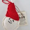 Hand-crocheted Santa Claus Christmas ornament with red hat and white pom-pom, smiling face and braided loop.