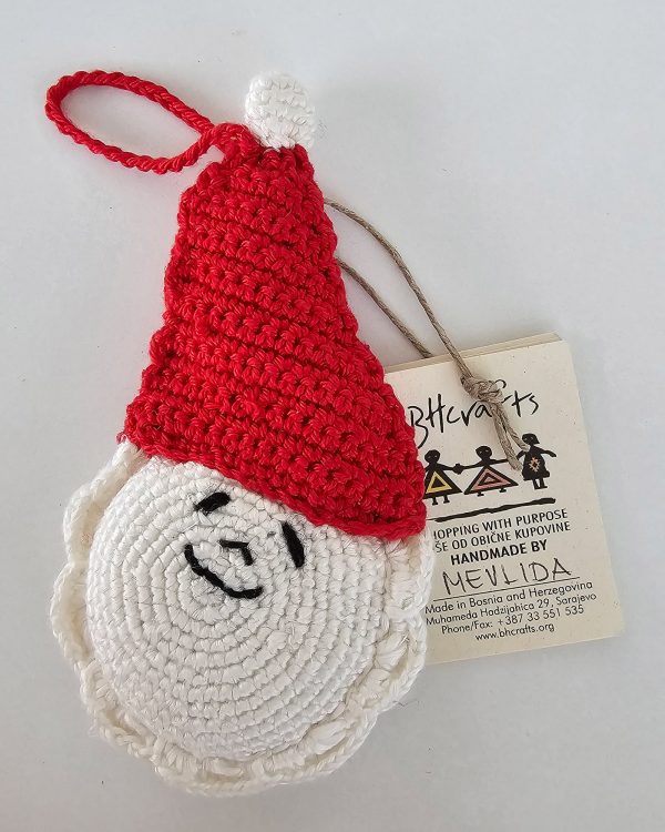 Hand-crocheted Santa Claus Christmas ornament with red hat and white pom-pom, smiling face and braided loop.