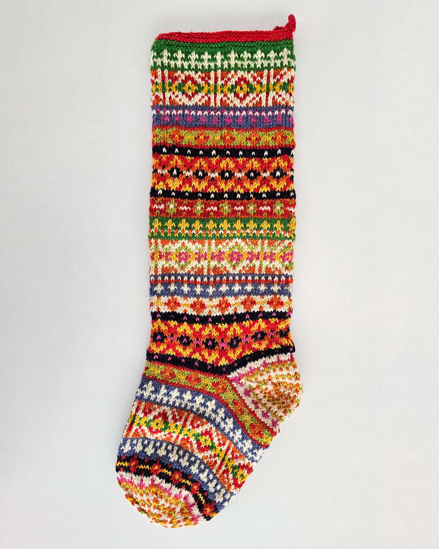 Handmade knit Christmas stocking with colorful traditional fair isle pattern