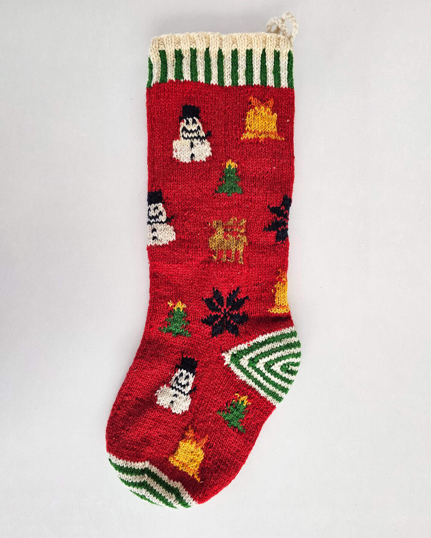 Colorful knitted Christmas stocking decorated with playful snowmen and festive holiday patterns