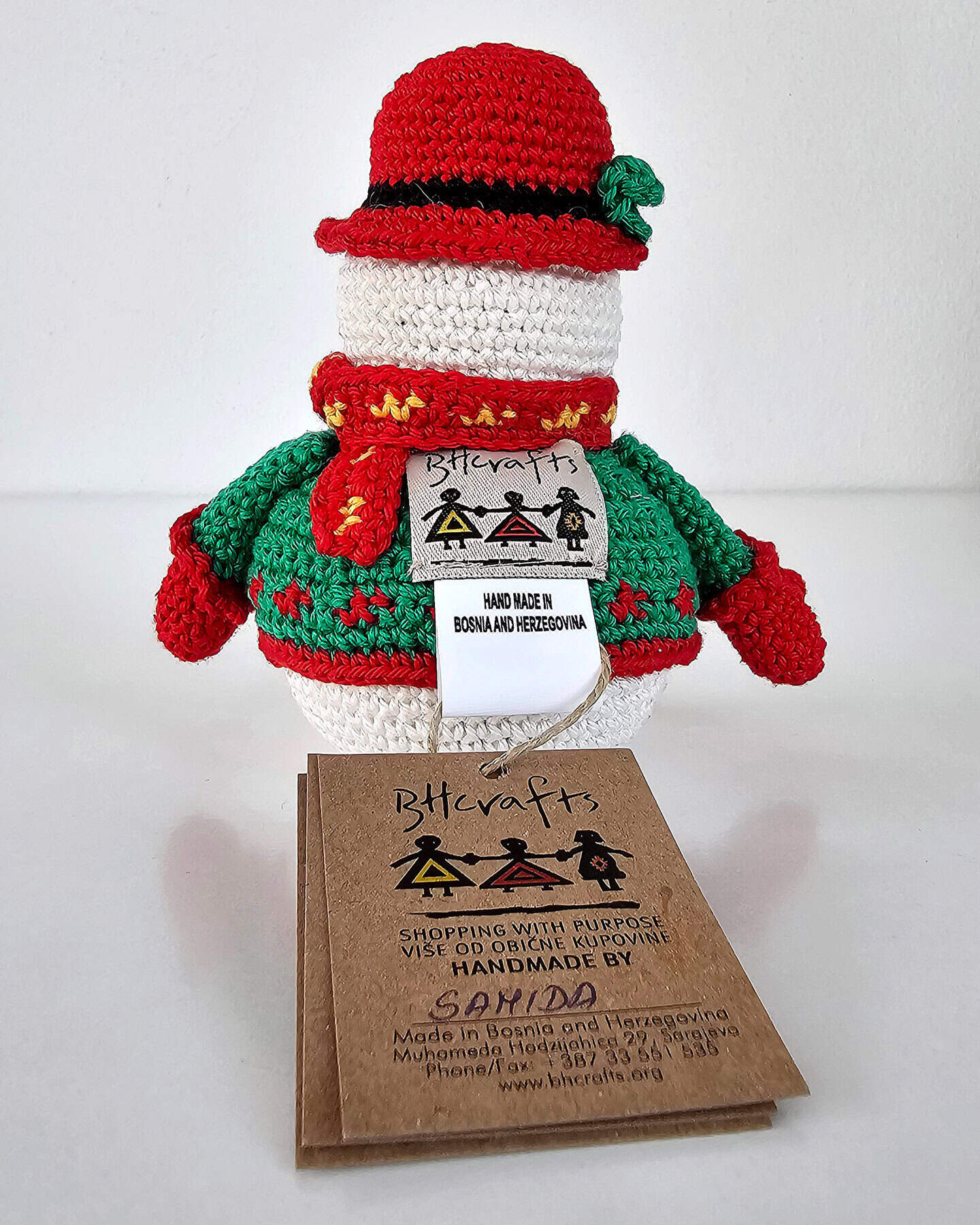 Fair-trade crochet snowman eco-friendly christmas decoration in festive red and green outfit