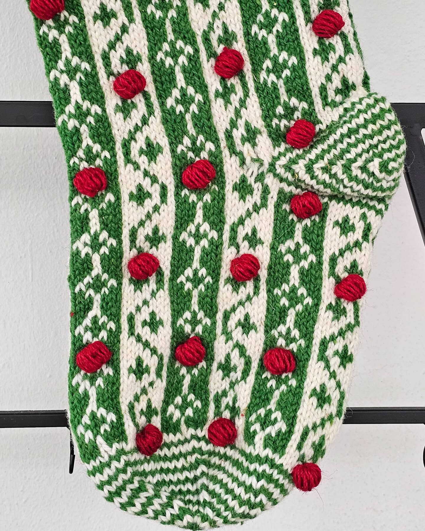 WFTO fair trade handmade Christmas stocking with red, green, and white knit patterns