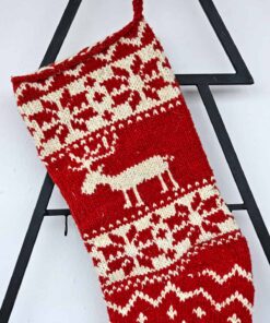 Handmade holiday stocking with red background and cream reindeer