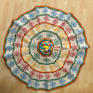 Artisan-Made Hand-knit Fair Trade Christmas tree skirt with colorful snowflake pattern
