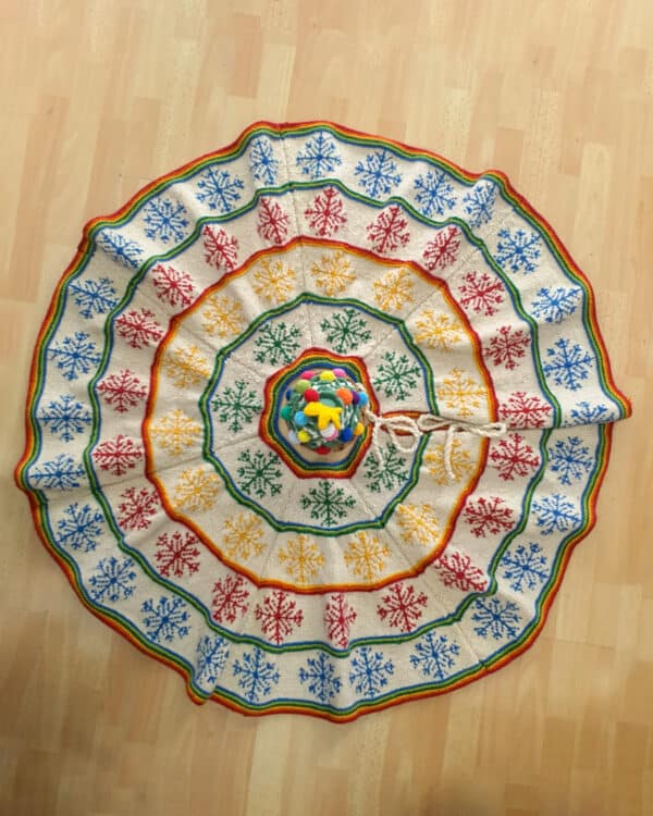 Artisan-Made Hand-knit Fair Trade Christmas tree skirt with colorful snowflake pattern