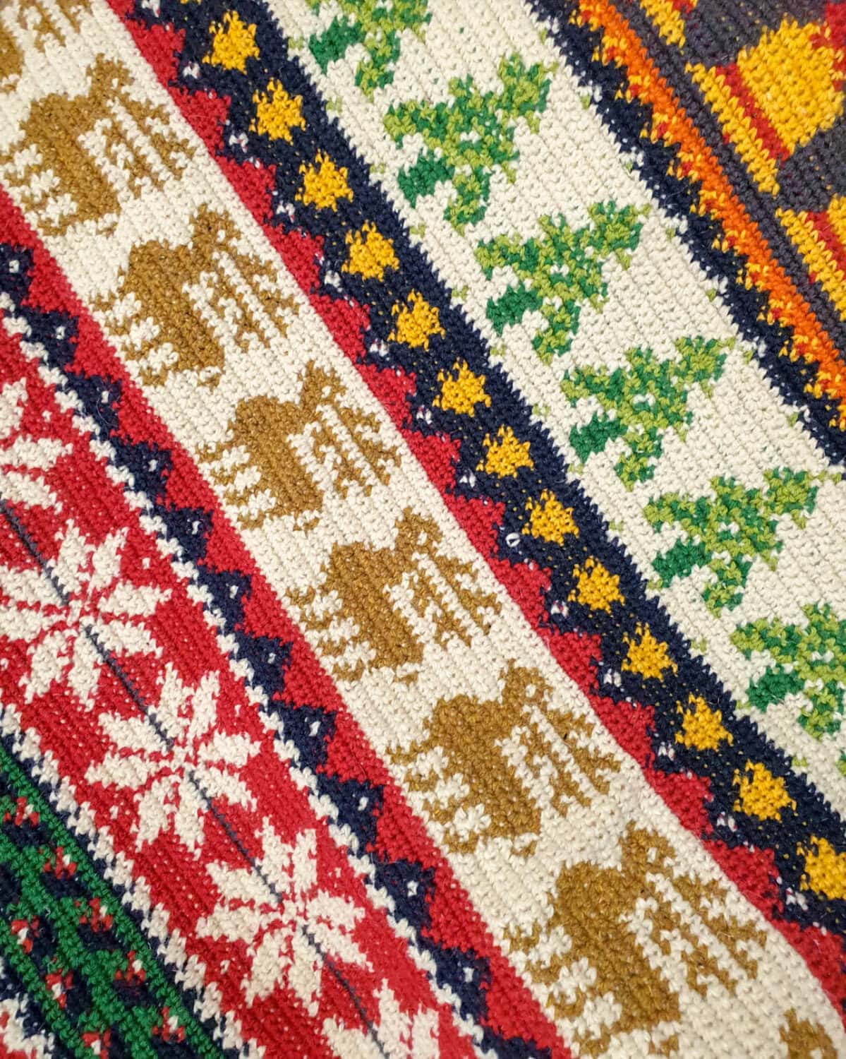 Fair-Trade colorful handmade crochet blanket with festive holiday pattern of snowflakes and trees