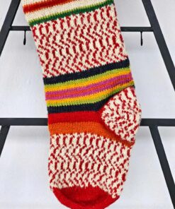 Handmade knit Christmas tree stocking in red, green, blue, and gold stripes. Part of limited edition.