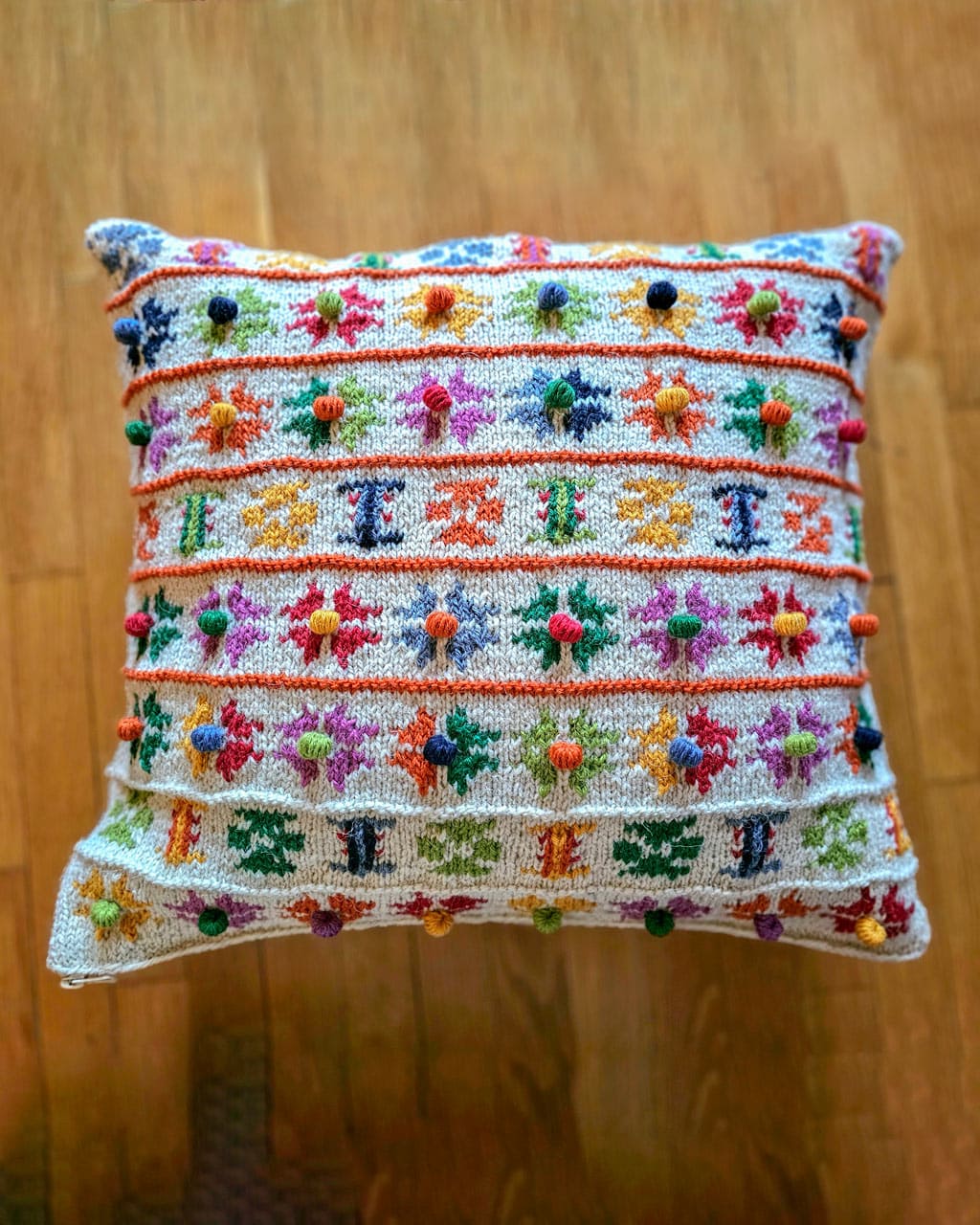 Handmade flower pillow cover on the wooden floor