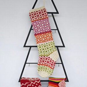 Hand-knit Christmas tree stocking with red, green, orange, and purple patterns