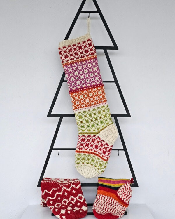 Hand-knit Christmas tree stocking with red, green, orange, and purple patterns