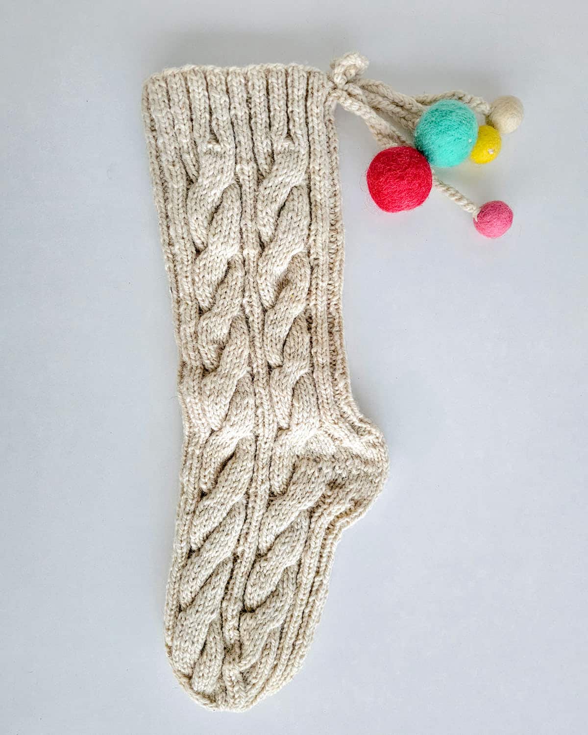Holiday stockings handmade with natural yarn and traditional patterns.