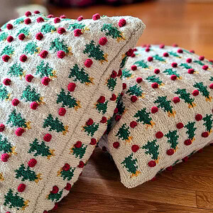Two fair trade handmade Christmas pillows with matching tree and pom-pom designs