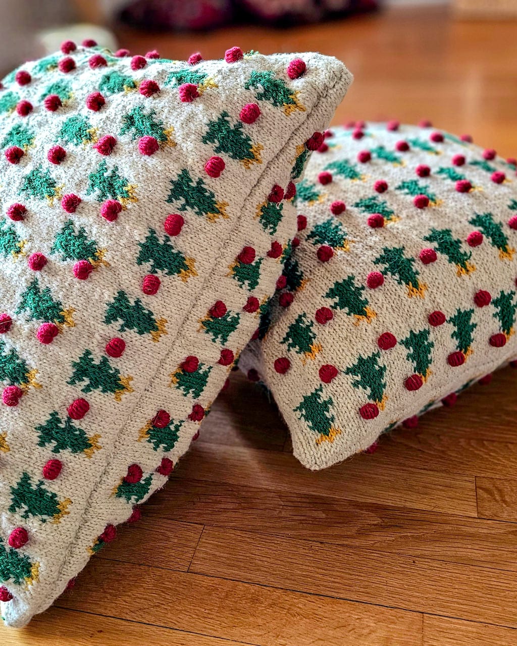 Two fair trade handmade Christmas pillows with matching tree and pom-pom designs