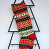 Handmade Christmas tree stocking with colorful Fair Isle pattern in red, green, blue, and yellow