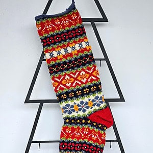 Handmade Christmas tree stocking with colorful Fair Isle pattern in red, green, blue, and yellow