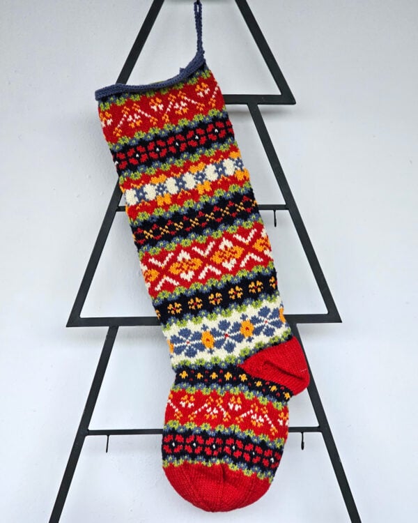 Handmade Christmas tree stocking with colorful Fair Isle pattern in red, green, blue, and yellow