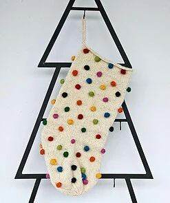 Hand-knit holiday stocking with multicolor pom-poms. Limited edition Christmas tree stocking