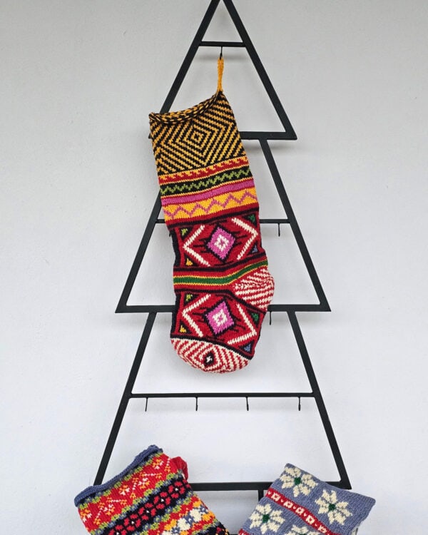 Hand-knit Christmas stocking with colorful geometric patterns and hanging loop