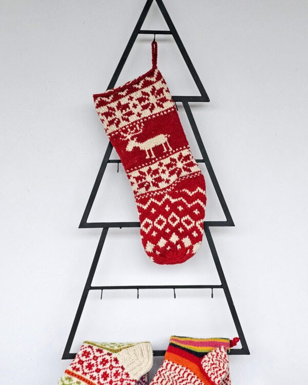 Hand-knit red Christmas stocking with cream reindeer and snowflake motifs. Limited edition!