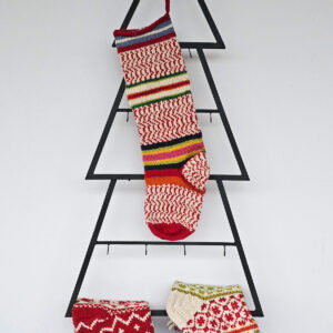 Hand-knit Christmas tree stocking with red and white knit and colorful stripes