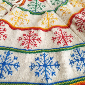 Close-up of hand-knit Christmas tree skirt snowflake pattern