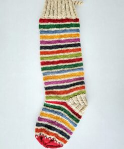 Festive holiday stocking in red, green, white stripes with tree design