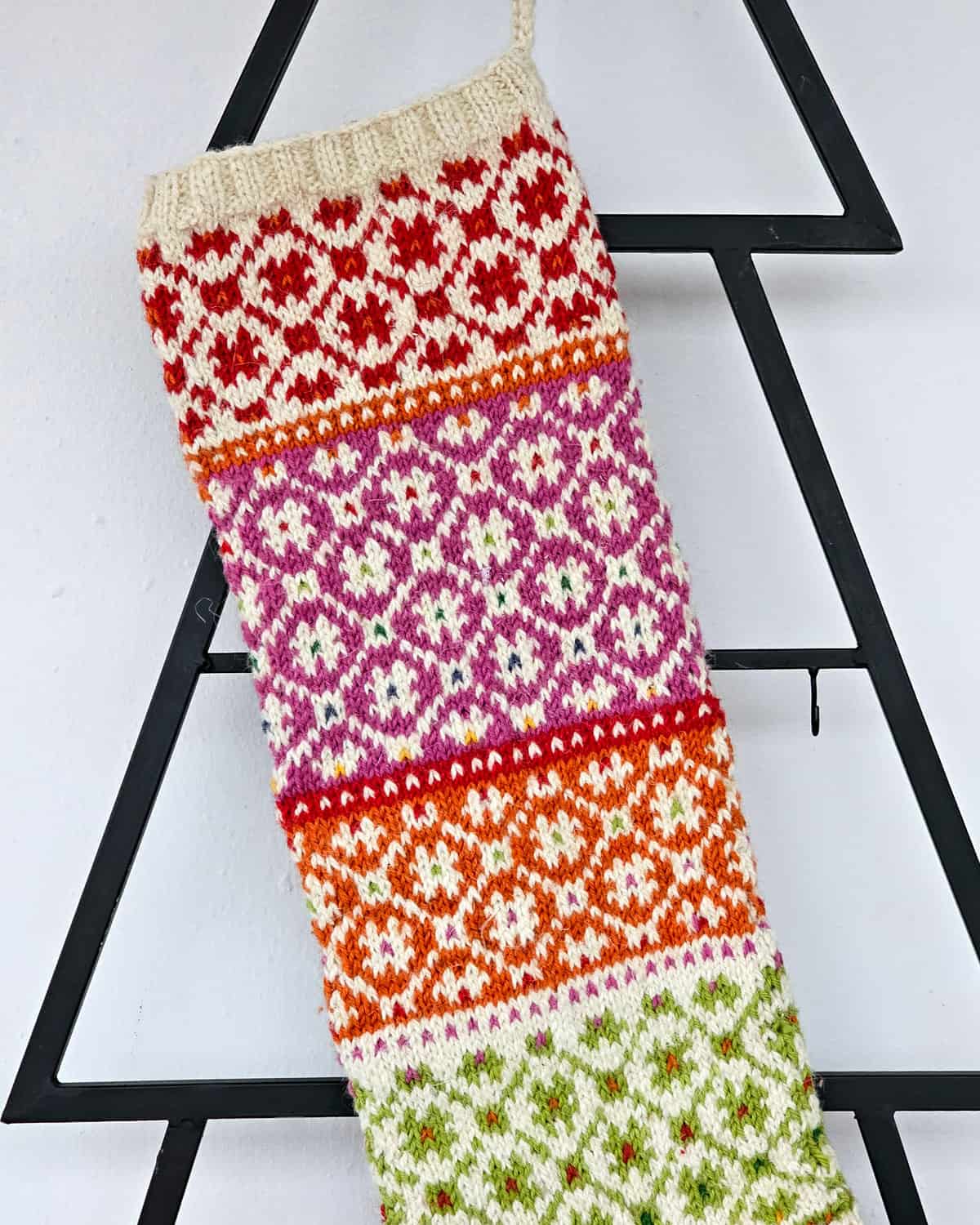 Artisan Christmas stocking featuring multicolor festive motifs