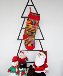 knitted Christmas stocking with vibrant square and rectangular patterns, ideal for personalization.