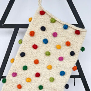Artisan pom-pom holiday stocking made of soft yarn