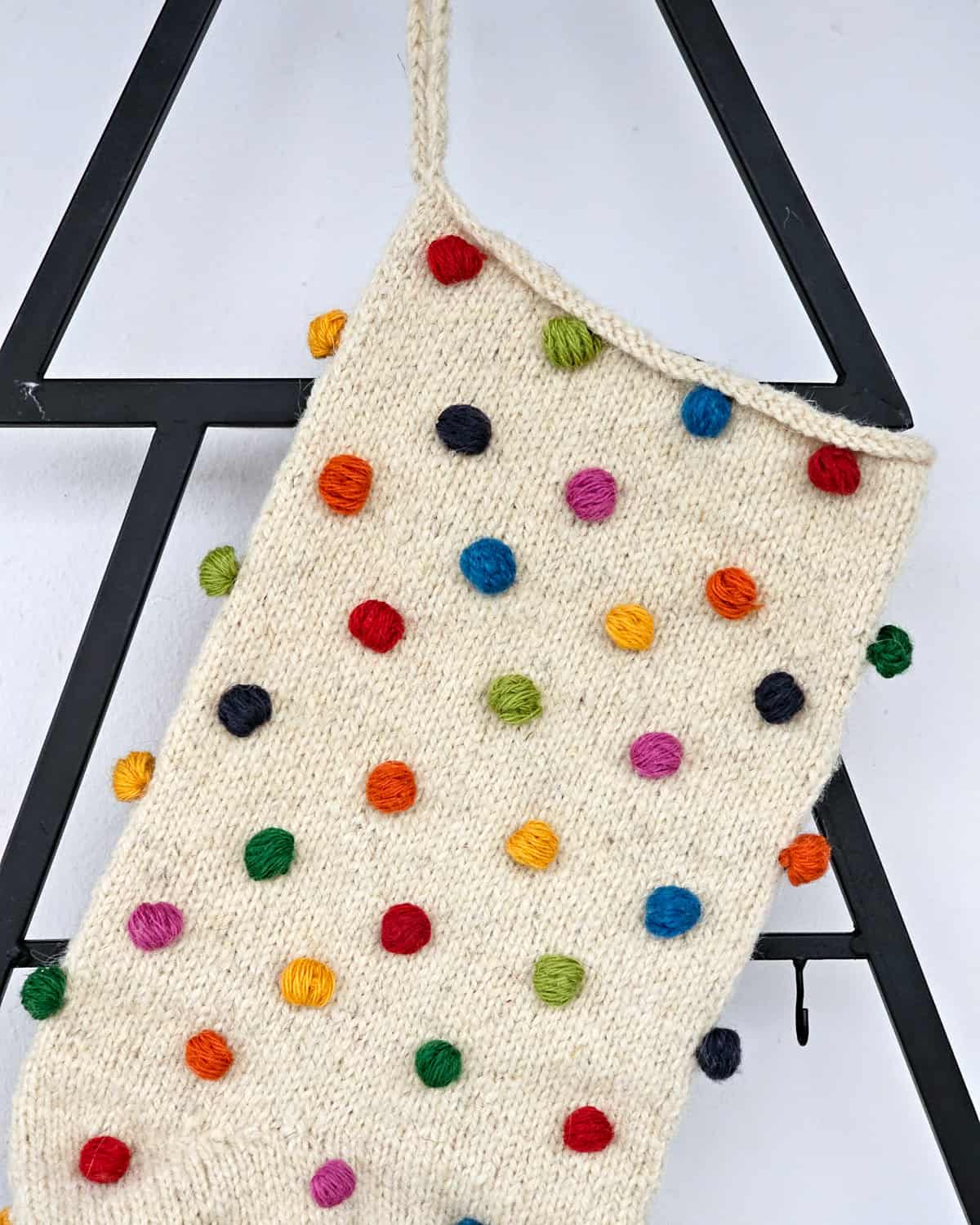 Artisan pom-pom holiday stocking made of soft yarn