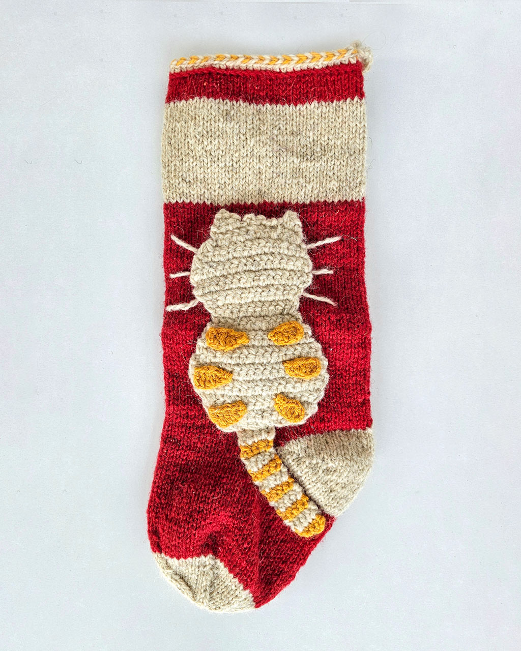 Artisan knit holiday stocking with multicolor cats