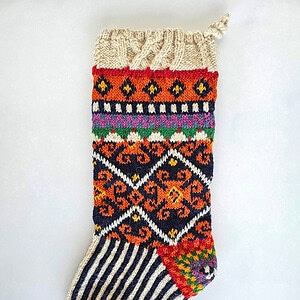 Artisan-made holiday stocking in orange, navy, and cream tones for your fair trade charm
