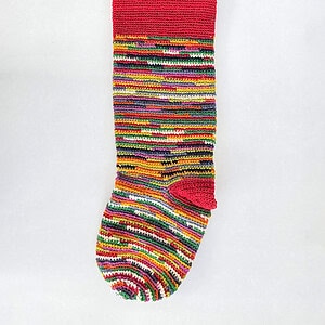 Handmade holiday tree stocking with striped cream base and bold striped pattern